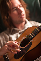 Image showing Young Musician Plays His Acoustic Guitar