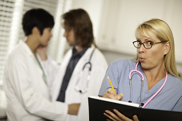 Image showing Alarmed Medical Woman Witnesses Colleagues Inner Office Romance.