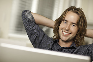 Image showing Happy Young Man Using Laptop Computer