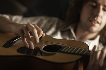 Image showing Young Musician Plays His Acoustic Guitar