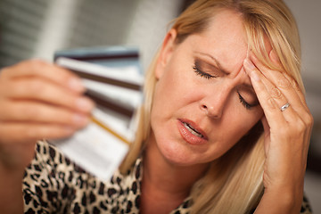 Image showing Upset Woman Holding Her Many Credit Cards