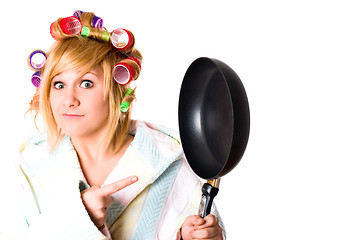 Image showing funny housewife with curlers and pan