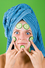 Image showing woman in blue towel and mask from cucumber