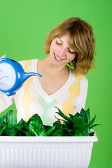 Image showing girl watering flowers