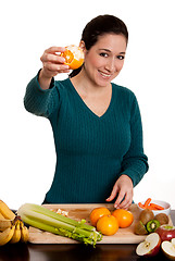 Image showing Woman presenting peeled ornage fruit