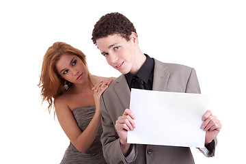 Image showing young couple, man holding  a paperboard in hand,she looking for him,