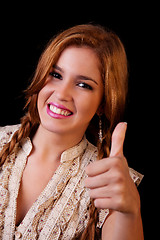 Image showing Young pretty women with thumb raised as a sign of success, thumbs up
