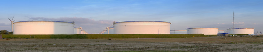 Image showing Oil tanks at sunset