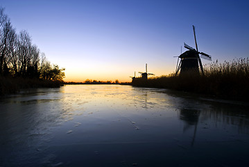 Image showing Windmills at sunrise