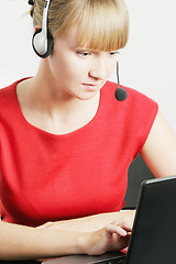 Image showing Call center employee looking at laptop