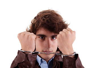 Image showing Arms on the face, of a young man, with a handcuffs on the hands