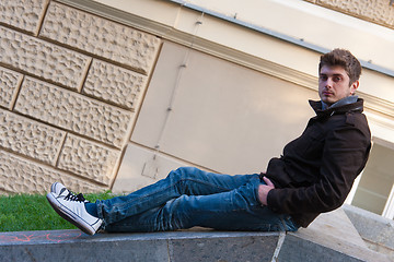 Image showing Young man sitting on slope steps