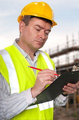 Image showing Construction foreman checks clipboard