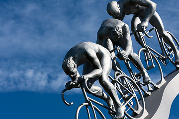 Image showing Three cyclists in a slope