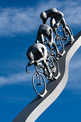 Image showing Three cyclists in a slope