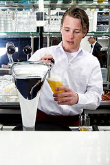 Image showing bartender tapping beer 