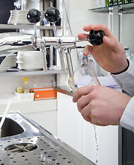 Image showing Pouring a beer