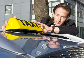 Image showing Placing the Taxi sign