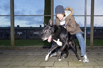 Image showing Vicious dog leaping away from his owner