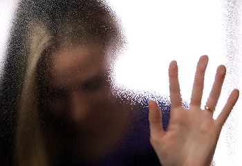 Image showing A girl behind the glass   