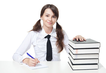 Image showing Happy schoolgirl with stack of books