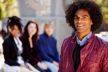 Image showing Four People with One Man as Focal Point