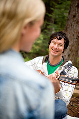 Image showing Man Serenading a Woman with Guitar