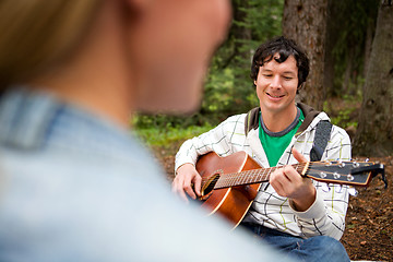 Image showing Man Playing Guitar for Woman