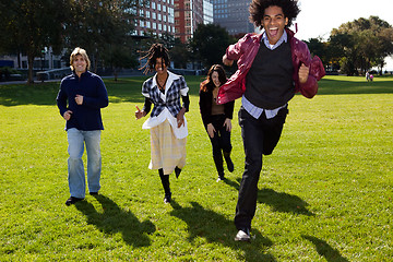 Image showing Four People Running Through an Urban Park
