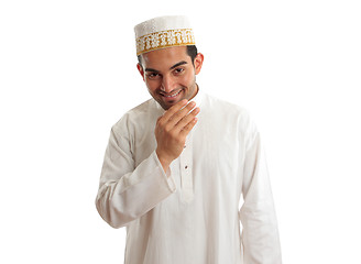 Image showing Smiling ethnic man in traditional robe and topi