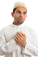 Image showing Ethnic man holding his hands to his chest