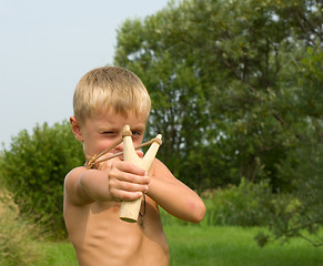 Image showing Child with a slingshot.