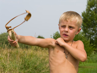 Image showing Boy with a slingshot.