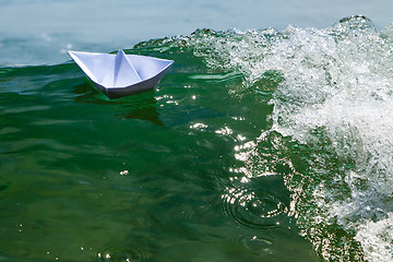 Image showing Paper boat struggling with a huge foamy waves