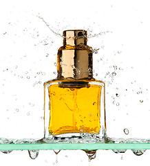 Image showing Bottle of perfume in a spray of water