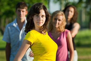 Image showing A young girl stands in a park