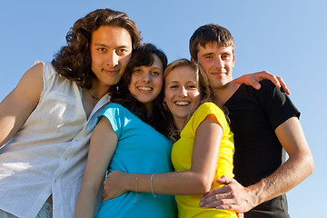 Image showing Happy young people against the sky