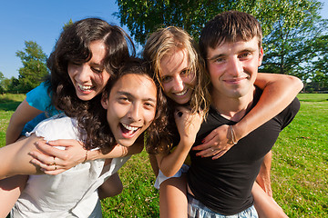 Image showing Four young people having fun in the park