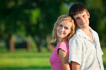 Image showing A couple of lovers in the summer are in the park early in the ev