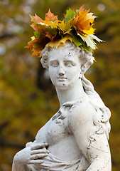 Image showing A wreath of autumn yellow leaves on her head a beautiful marble 