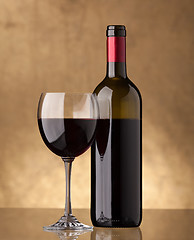 Image showing A bottle of red wine and filled a wine glass