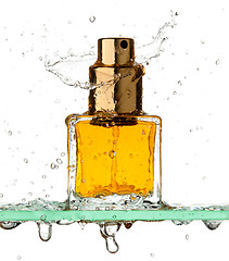 Image showing Bottle of perfume in a spray of water