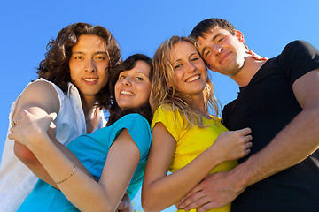 Image showing Young people, two girls and two boys, hugged each other