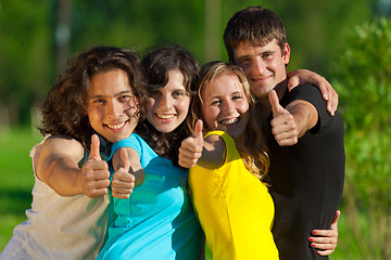 Image showing Young group of happy friends showing thumbs up sign