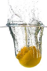 Image showing Lemon falling in a water