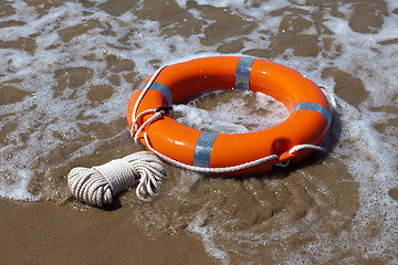 Image showing Red lifebuoy in foamy waves