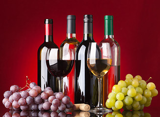 Image showing Bottles, glasses and grapes