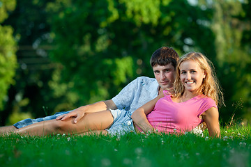 Image showing Couple resting on the grass in the park