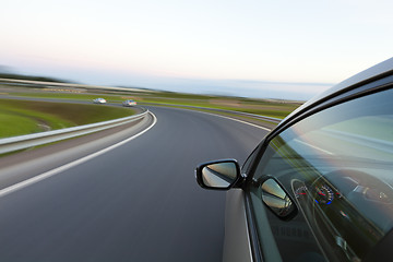 Image showing Car goes very fast to turn a country road