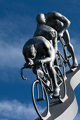 Image showing Three cyclists in a downhill